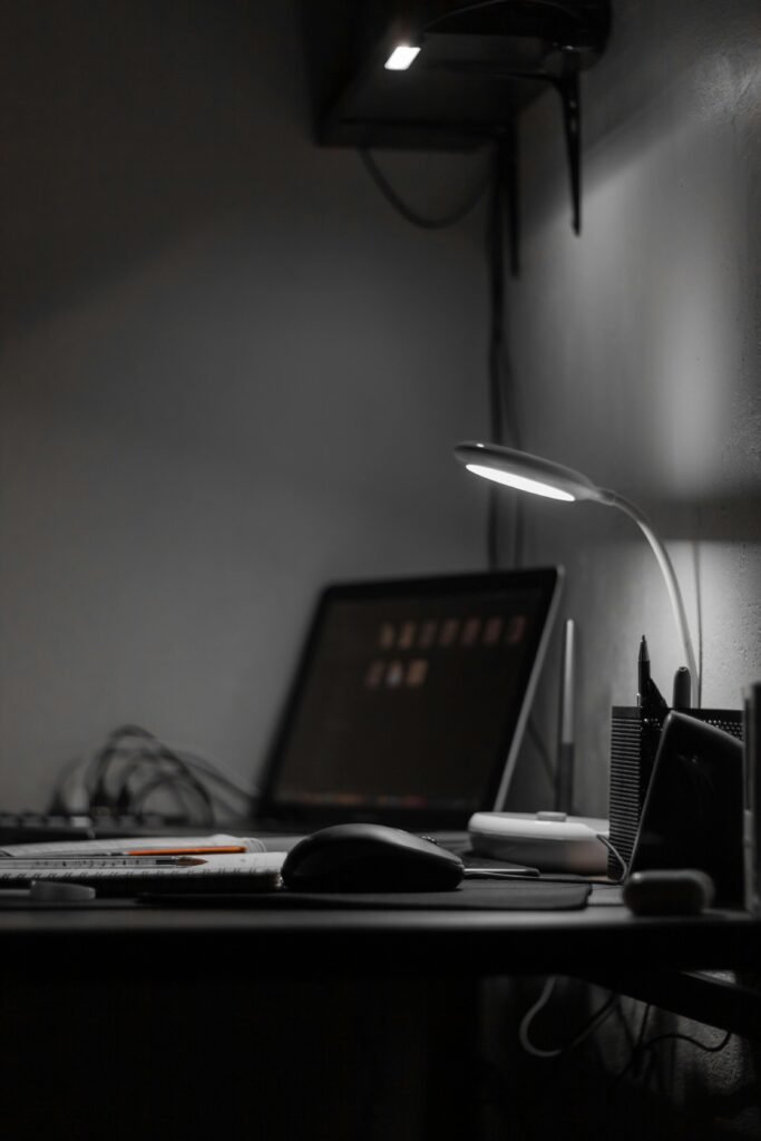 Top 10 Gifts for Tech-Loving Dads (2025 Edition) A sleek black and white office space with a laptop and LED desk lamp.